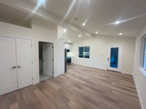 A view from the sleeping area shows the vaulted ceiling, bathroom to the left and the entry area.